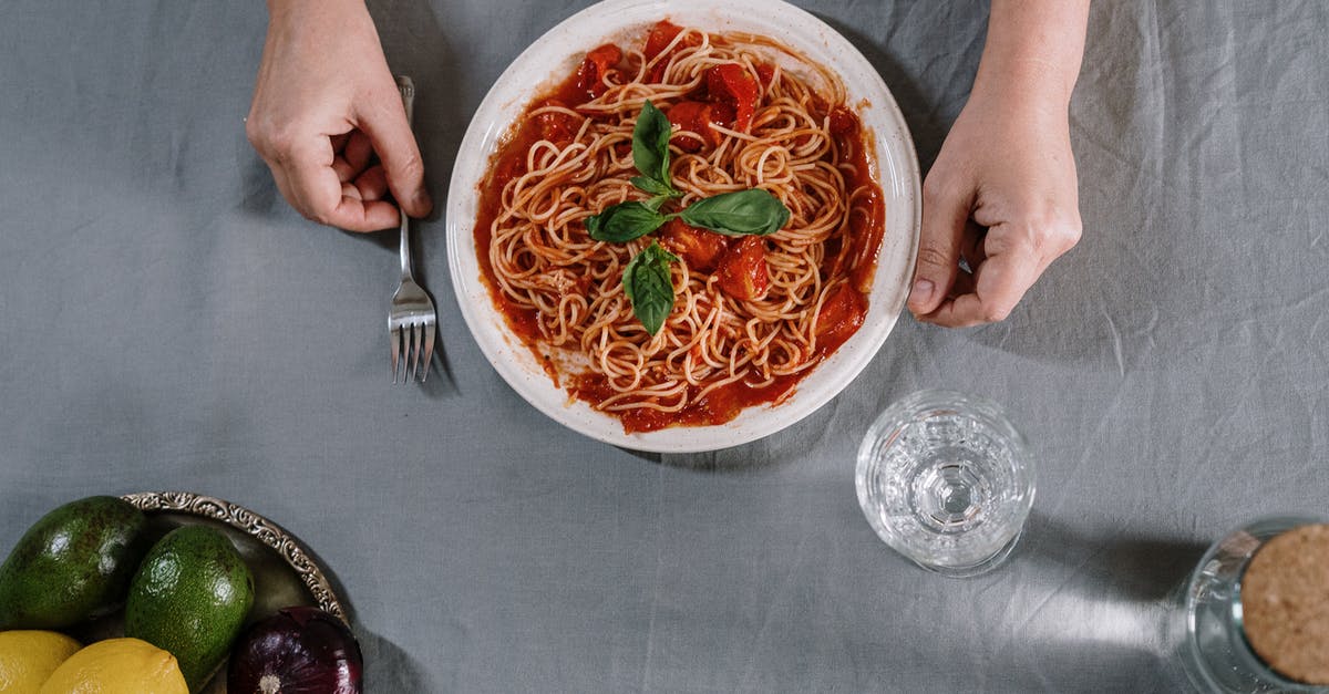 Bottled tomato sauce separated - A Plate Of Spaghetti On Table