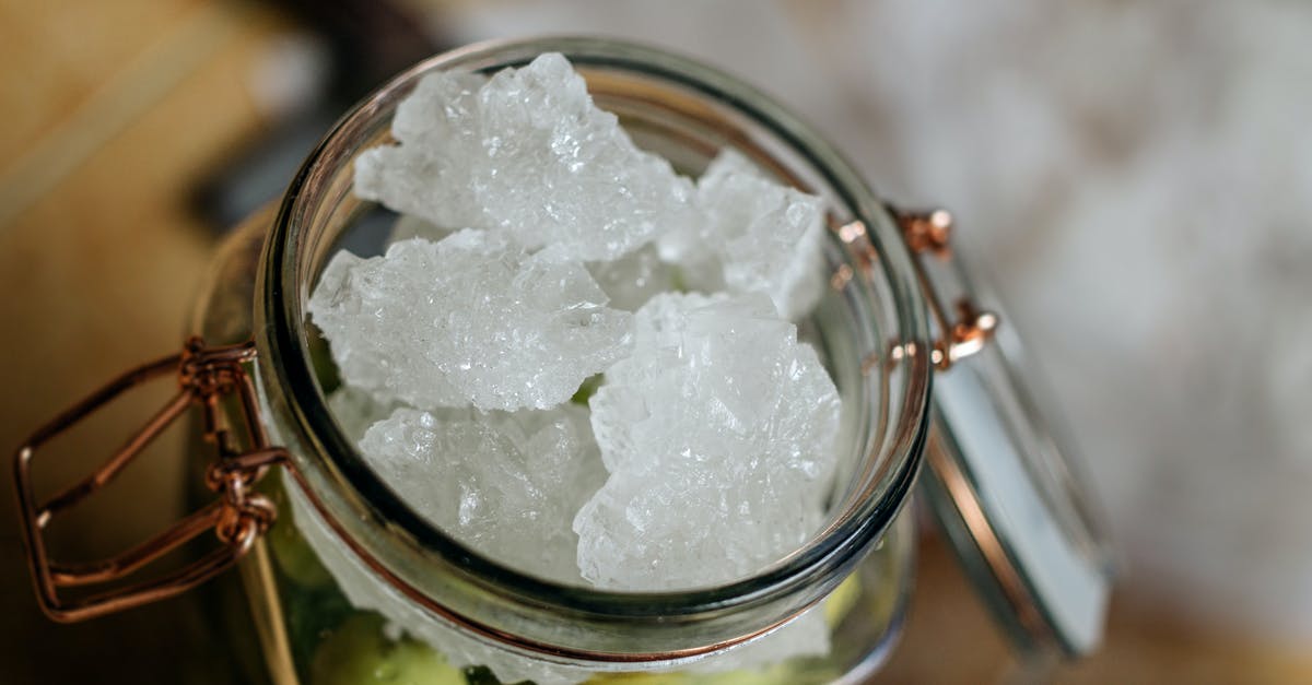 Botulism, Garlic, Cold pressed Olive oil and mason jars - Opened jar with olives with ice on top