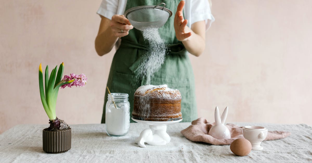 Breadcrumbs or flour when greasing and dusting a cake form? - Anonymous female serving cake with icing sugar