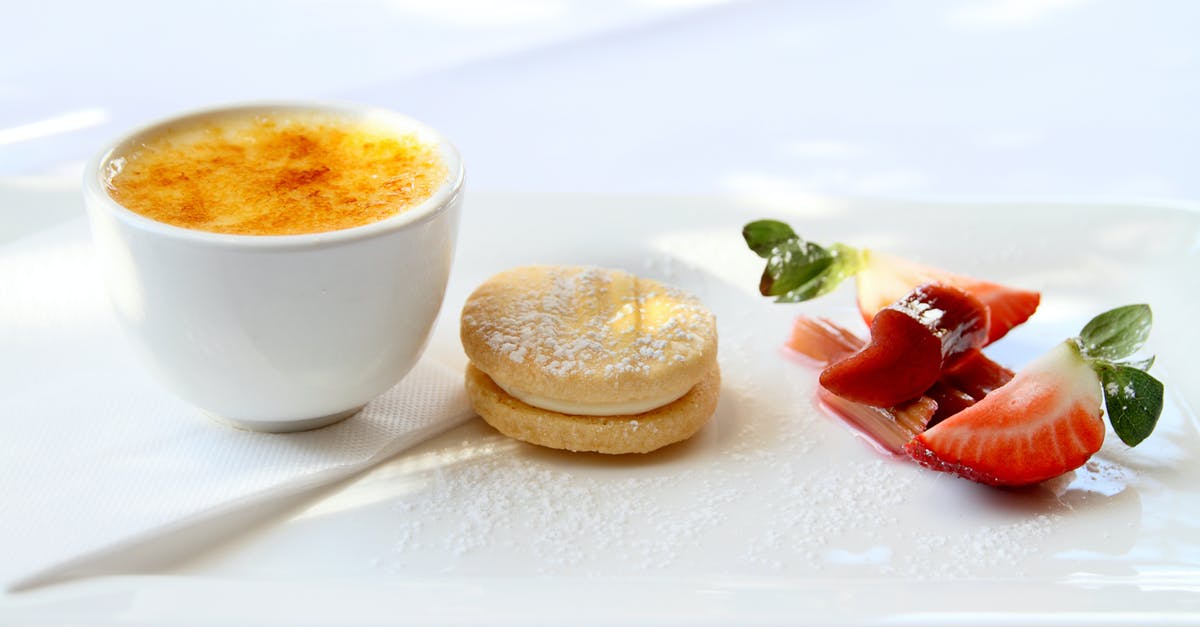 Breaking down fruit with sugar and water for cookies - Desserts over a White Surface