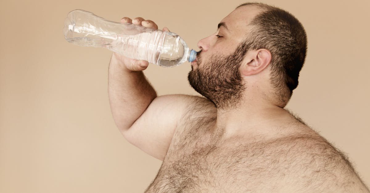 brined turkey and fat - Man Drinking from Clear Plastic Bottle