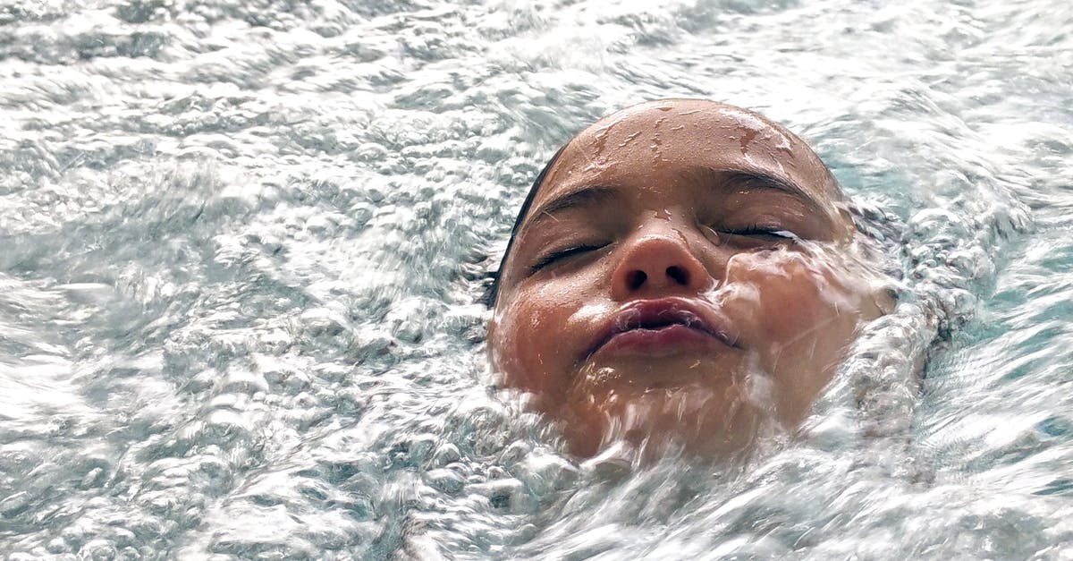 Bubbles on the Noodle surface - Woman on Body of Water during Daytime