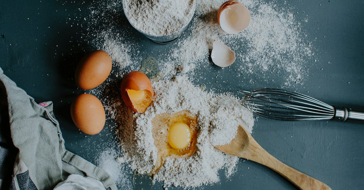 Bulk ingredient for keto/low carb flour substitute mix with gluten - Flour and broken eggs on table before dough kneading