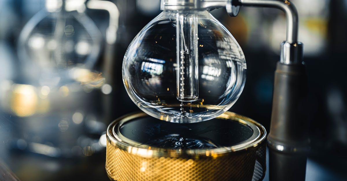 Bunn coffee maker parts cannot be identified - Professional vacuum coffeemaker with glass bottom bowl and burner placed on table in modern coffee house with equipment on blurred background