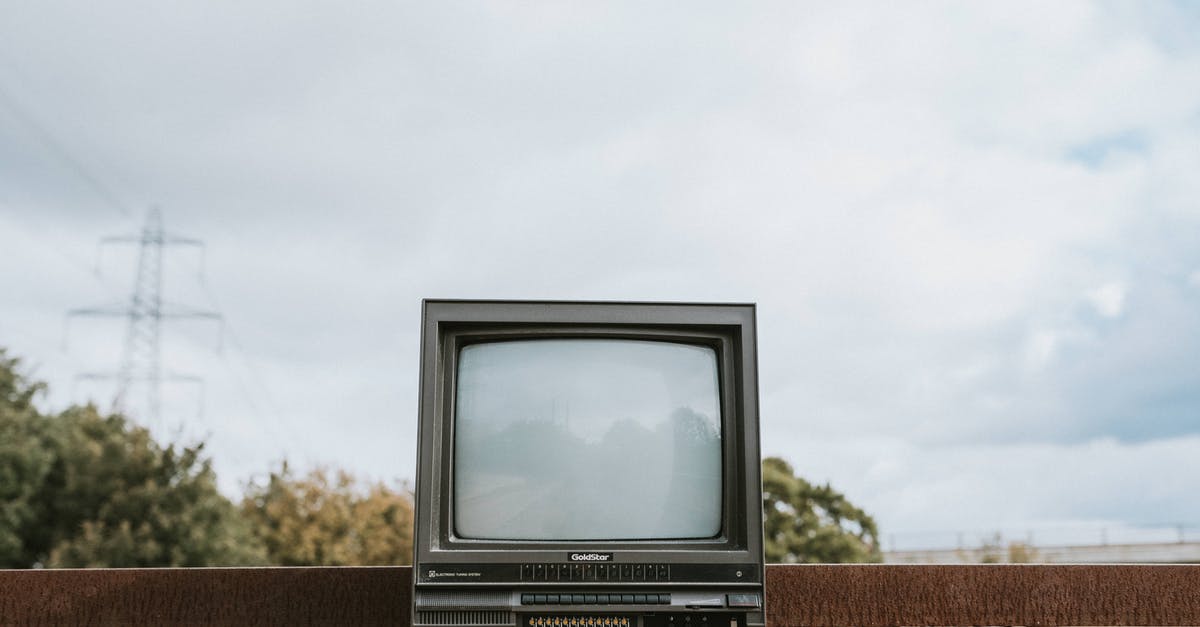 Burned / black pizza stone - Retro TV set placed on stone surface