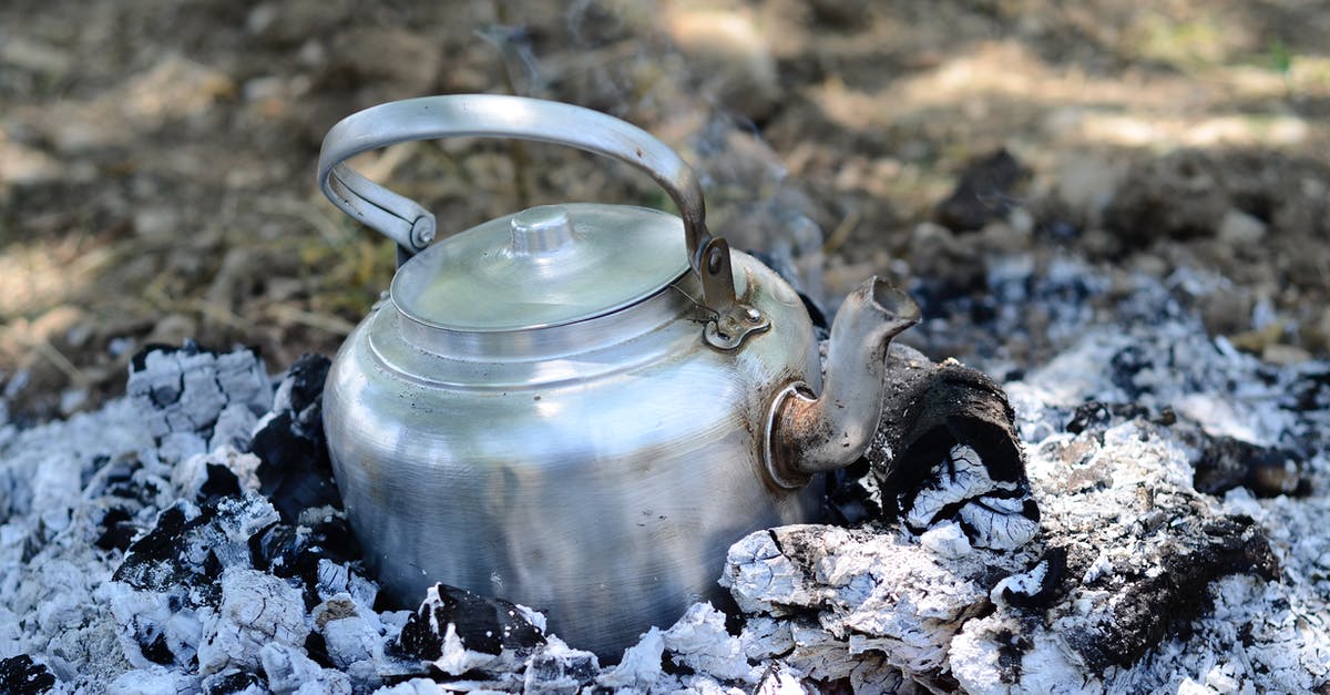 Burned enameled cast iron stock pot - A Kettle Pot on Burning Charcoal