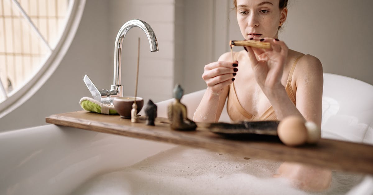 Burning crumpet bottoms - Woman in Bathtub Holding Toothbrush