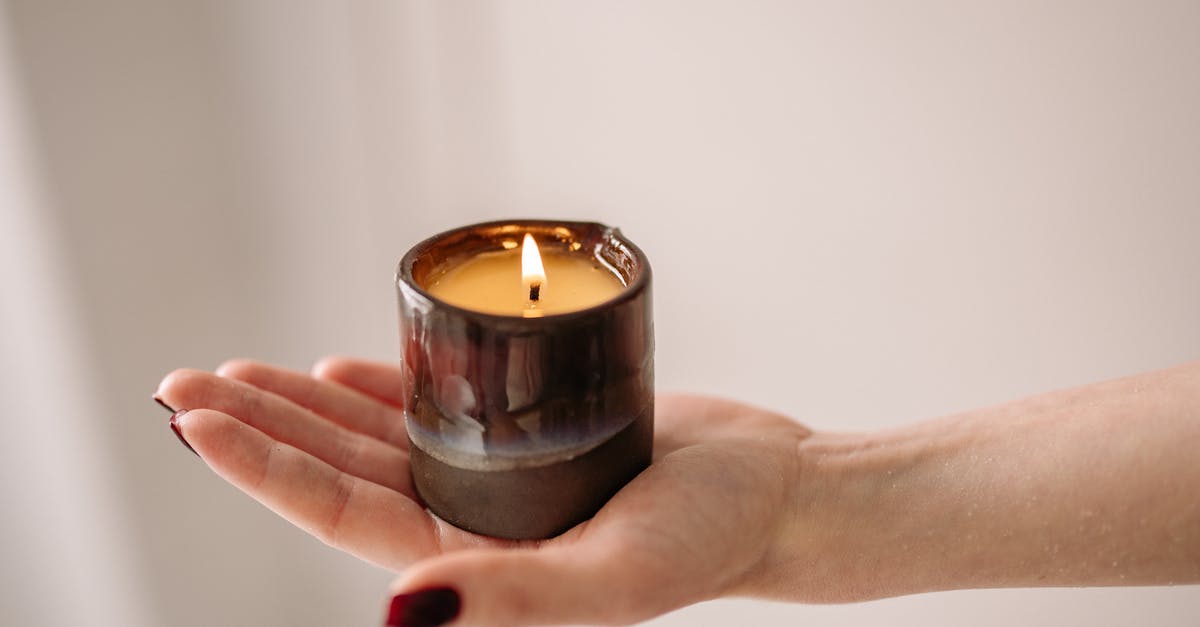 Burning crumpet bottoms - Person Holding Black Candle Holder