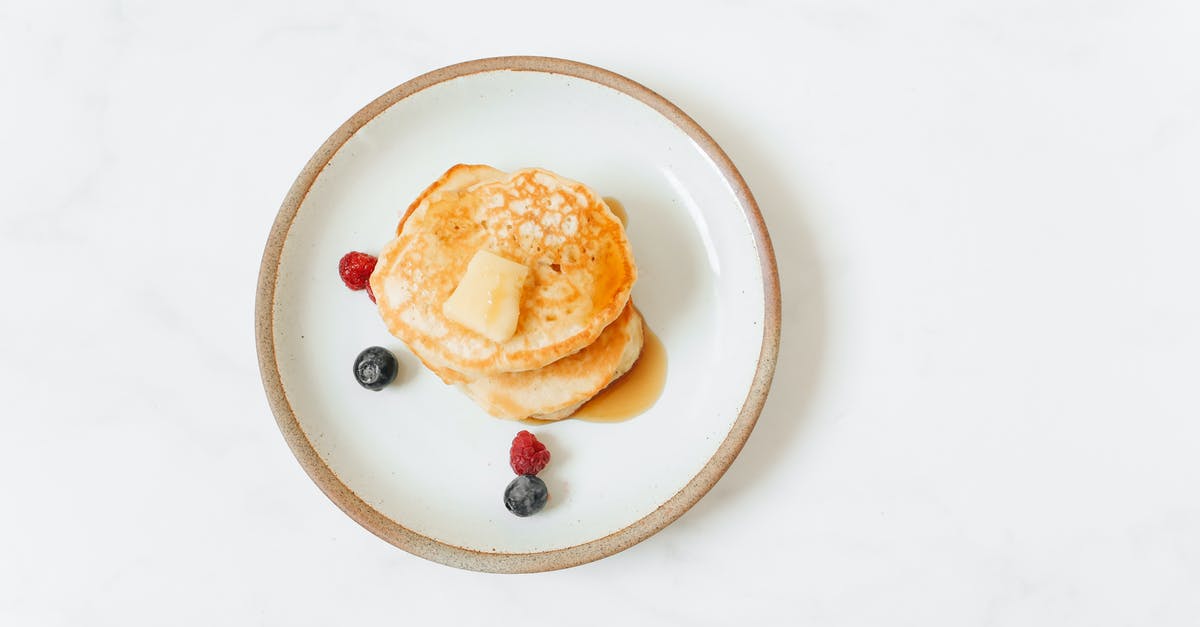 Butter melted then soften - Pancakes With Red and Black Berries on White Ceramic Plate