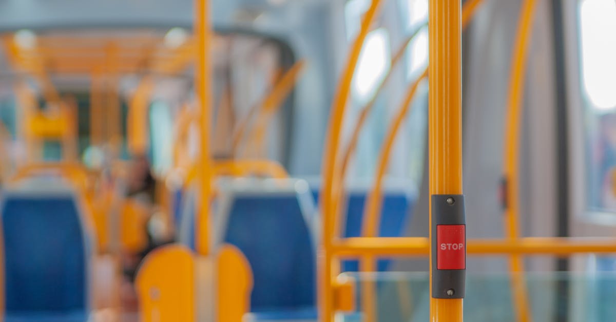 button mushrooms turned red while frying in butter - Red stop button on yellow handrail in modern empty public bus during daytime