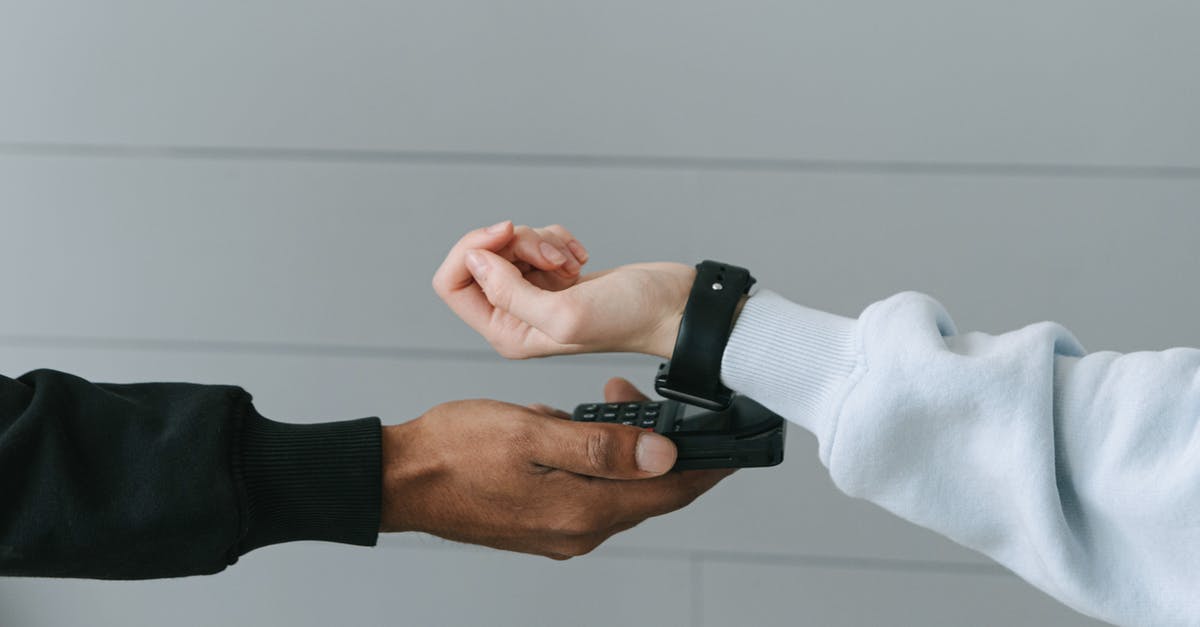 Buying chocolate transfer sheet - Person Paying Using Her Smartwatch