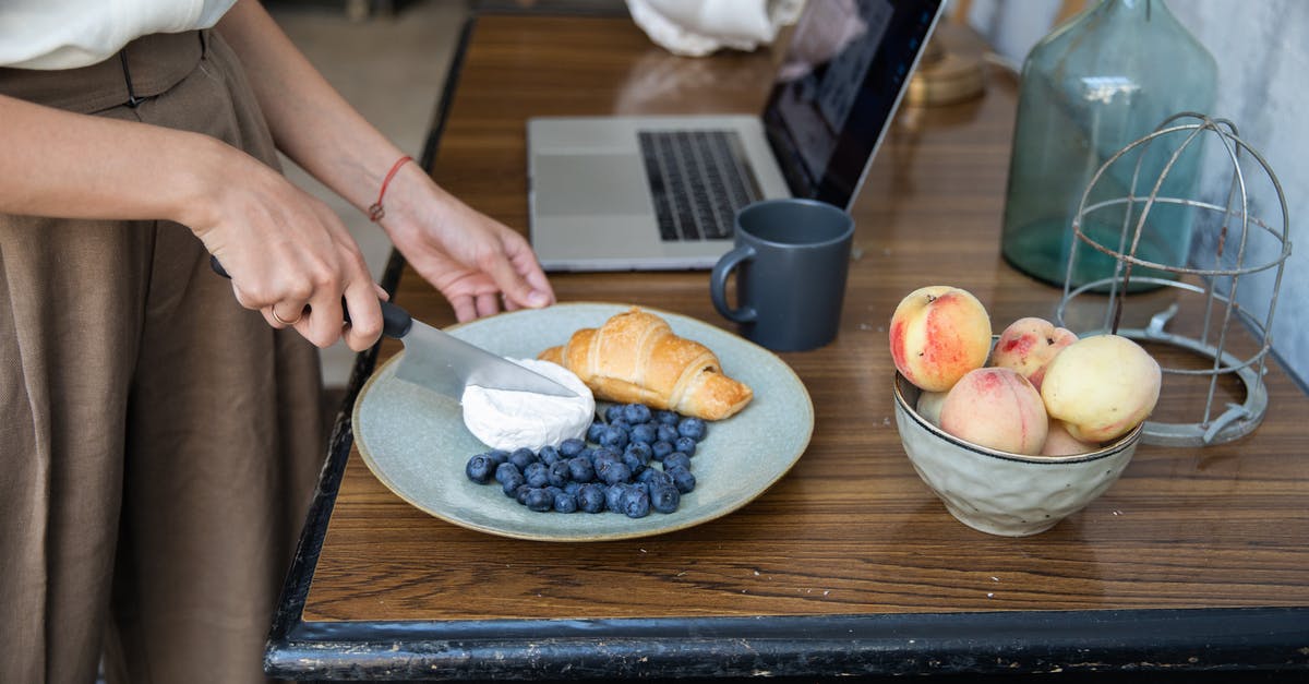 CaCl2 and cheese making - Person Slicing Apple on Brown Wooden Table