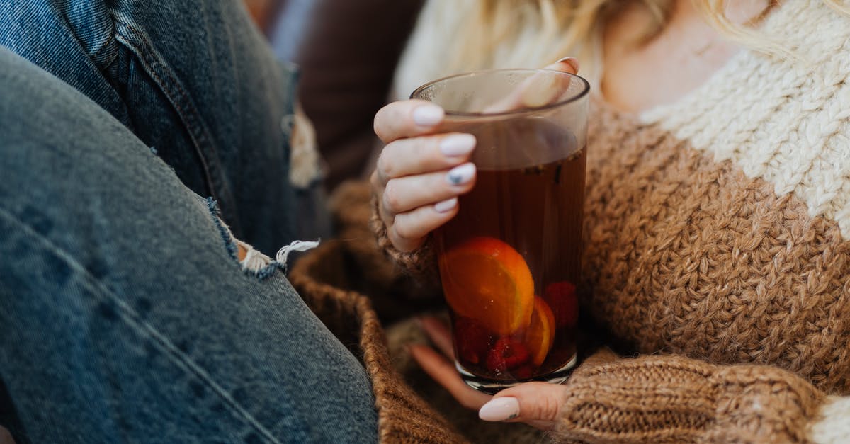 Calibrating tea dosage - Woman Holding Tall Glass of Tea