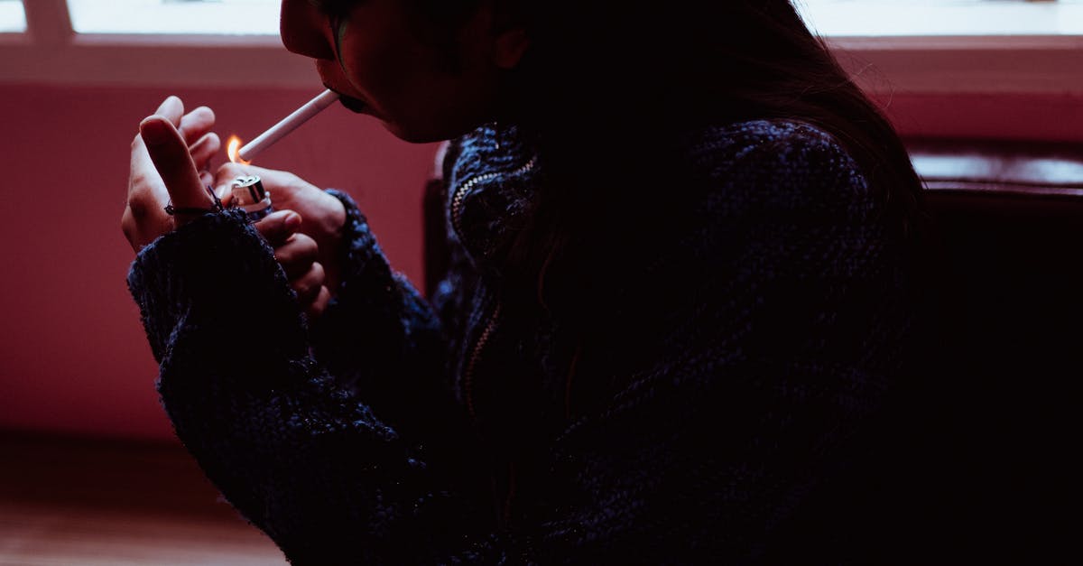 Can a few bad (dead) mussels harm a larger batch? - Woman smoking cigarette in dark room