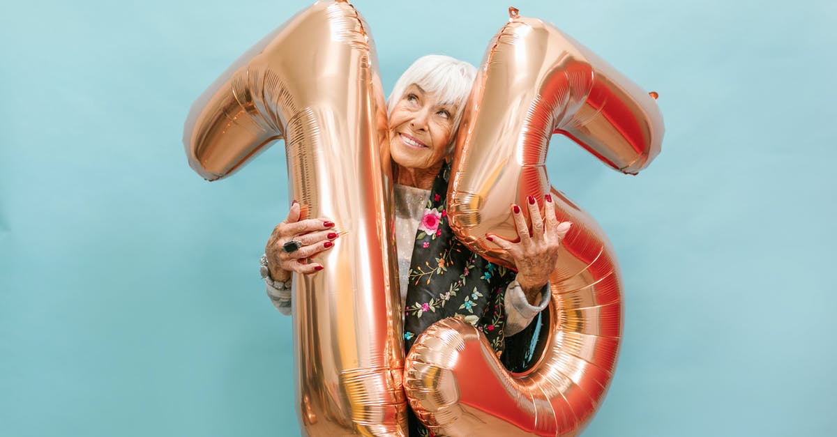 Can a large number of eggs be scrambled in a pot? - A Happy Elderly Woman Celebrating Her Birthday while Holding a Huge Balloon Numbers