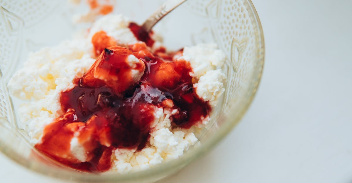 Can a sauce with dairy be jarred? - From above of appetizing cottage cheese with berry jam served in glass bowl with spoon on white table