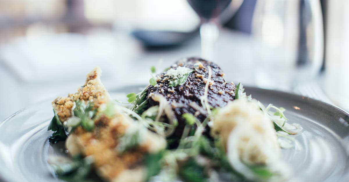 Can a steak be deep fried in clarified butter? - Tasty stuffed celery and grilled steak decorated with fresh green herbs served on plate on table in restaurant with wineglass on blurred background