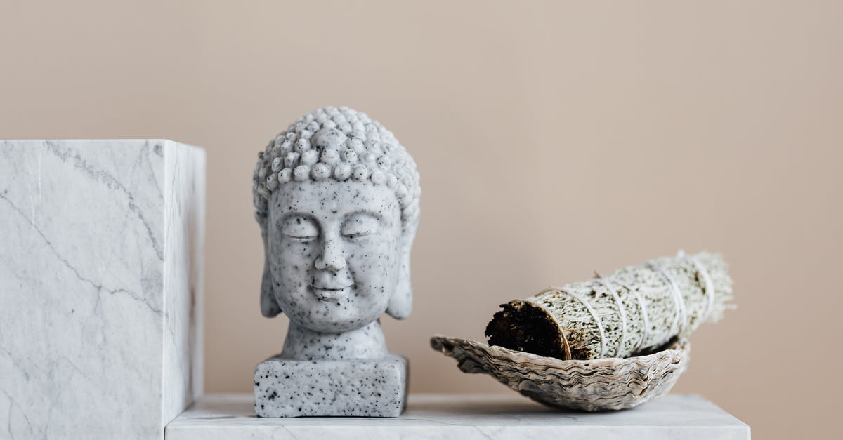 Can an old rosette “iron” that's starting to stick be reconditioned? - Stone Buddha and sage incense bundle in bowl on marble shelf