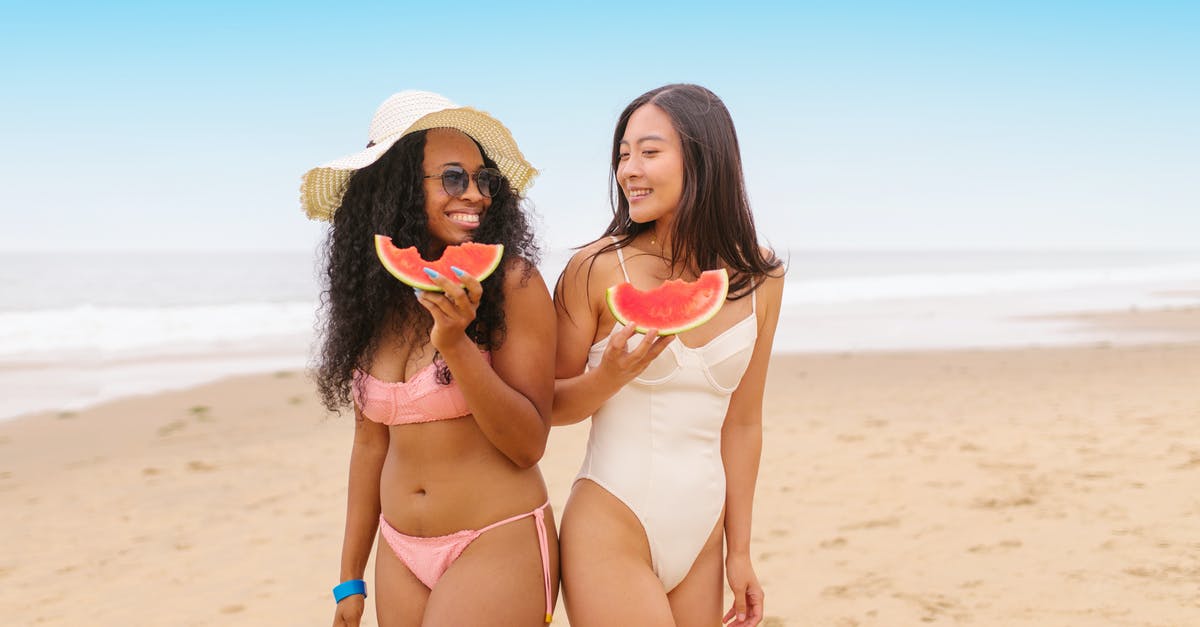 Can any harm come of eating watermelon seeds? - Women Eating Watermelon in the Beach