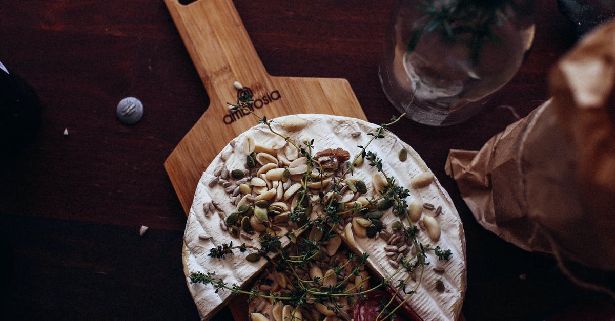 Can anyone explain the meaning of 2x and 4x brie cheese? - Delicious cheese and sausage garnished with nuts and herbs in restaurant