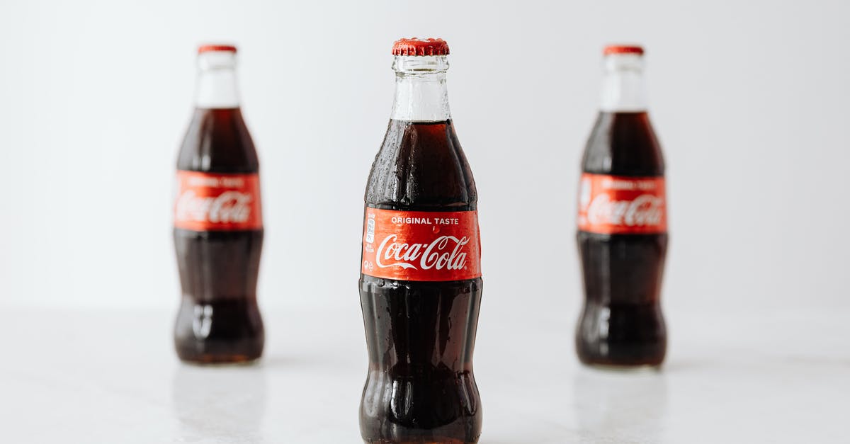 Can anyone identify this RED GINSENG CANDY? - Modern glass bottles of cold soda with red label placed on white reflective surface