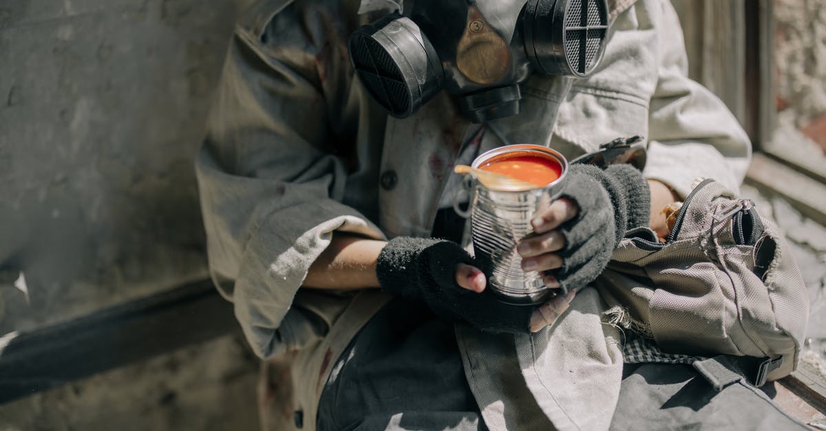 Can beans be overcooked? - Person in Gray Jacket Holding White and Red Ceramic Mug