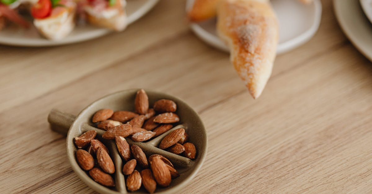 Can bitter almonds(or other nuts containing amygdalin) be made edible? - Almond Nuts on a Container on Wooden Surface