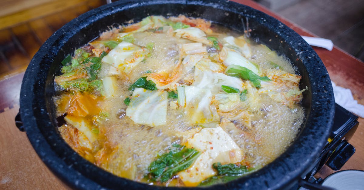 Can boiling a soup too low result in less flavor? - A Close-Up Shot of a Boiling Soup with Vegetables