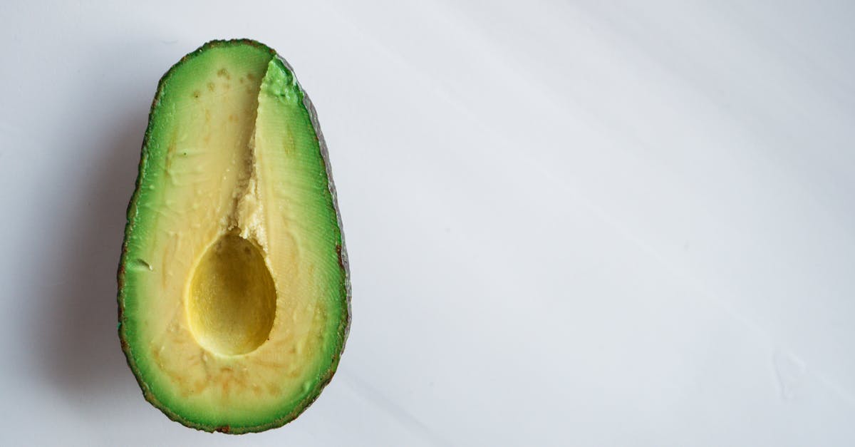 Can bright green avocados be ripe? - Half of ripe avocado on white background