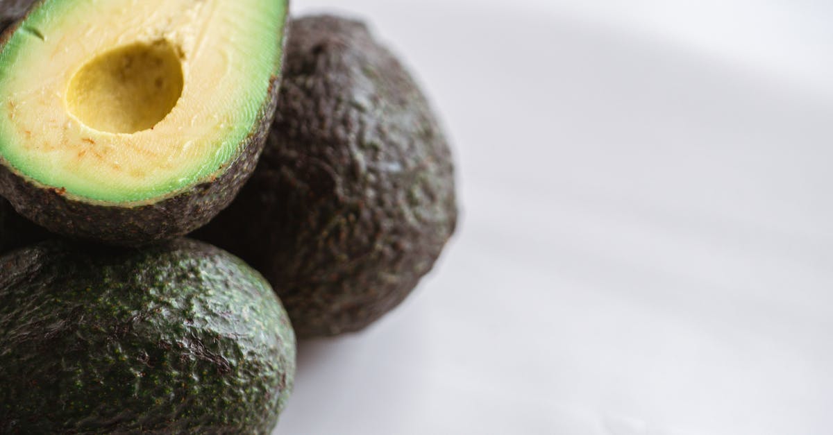 Can bright green avocados be ripe? - Fresh cut avocado on table in kitchen