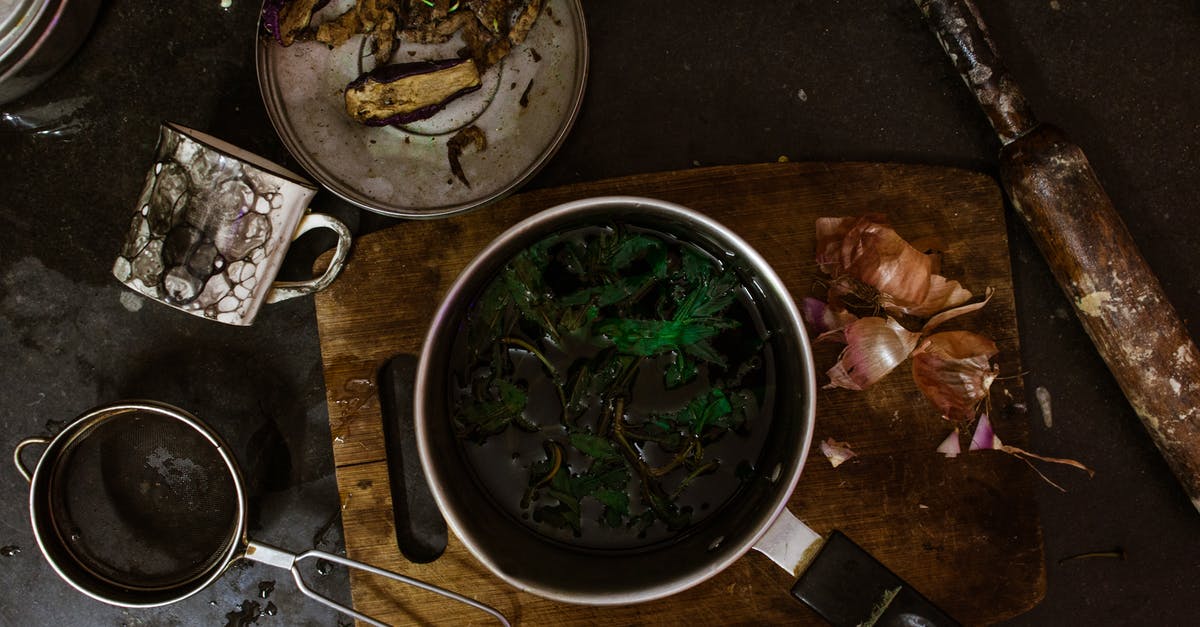 Can cooking or processing generate more natural sugars? - Top view of metal saucepan with broccoli on cutting board with onion near sieve and dirty mug