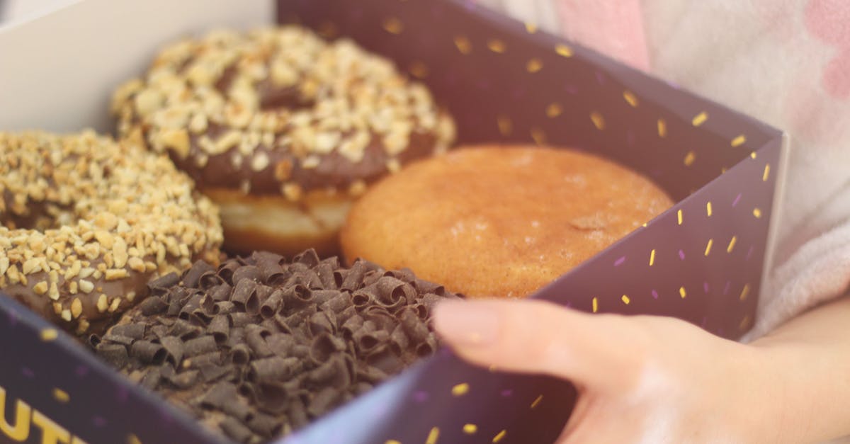 Can couverture chocolate be substituted with other ingredients? - Person Holding Box of Donuts