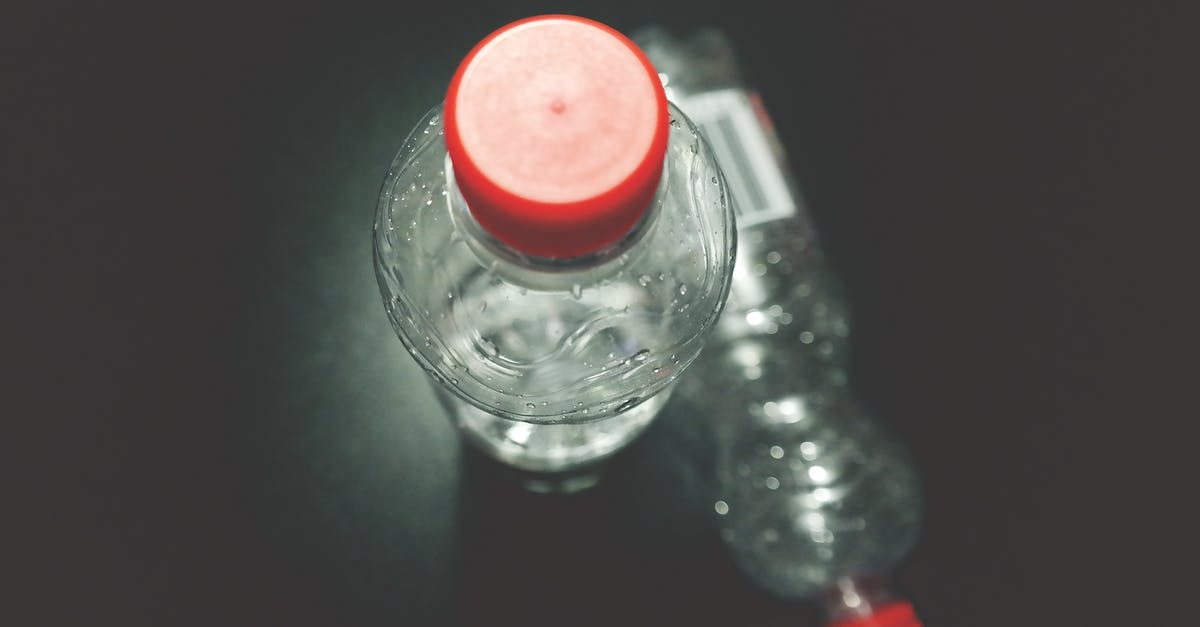Can distilled water in gallon plastic bottles expire? - Two Clear Plastic Bottles on Black Surface