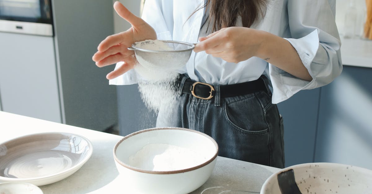 Can flour be used interchangeably with starch? - Woman in White Button Up Shirt Holding White Ceramic Bowl