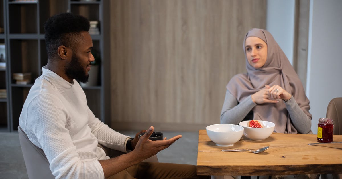 Can frozen peaches be made into jam or other things? - Positive young multiracial couple sitting at table and looking at each other while having breakfast together