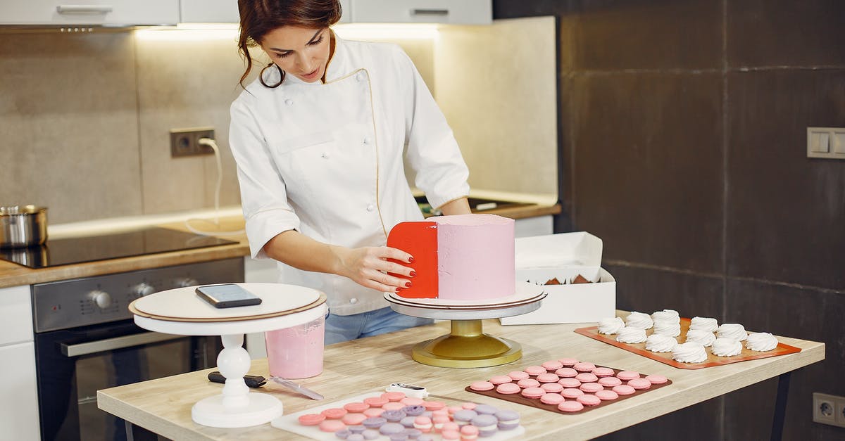Can I add double cream to my cake batter instead of sour cream? - Focused female pastry chef preparing cake and desserts with smartphone aside in modern kitchen