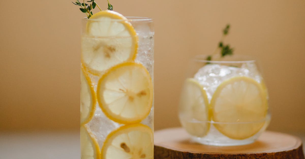 Can I avoid overcooking my candied lemon decorations? - Glasses with lemon drink on table