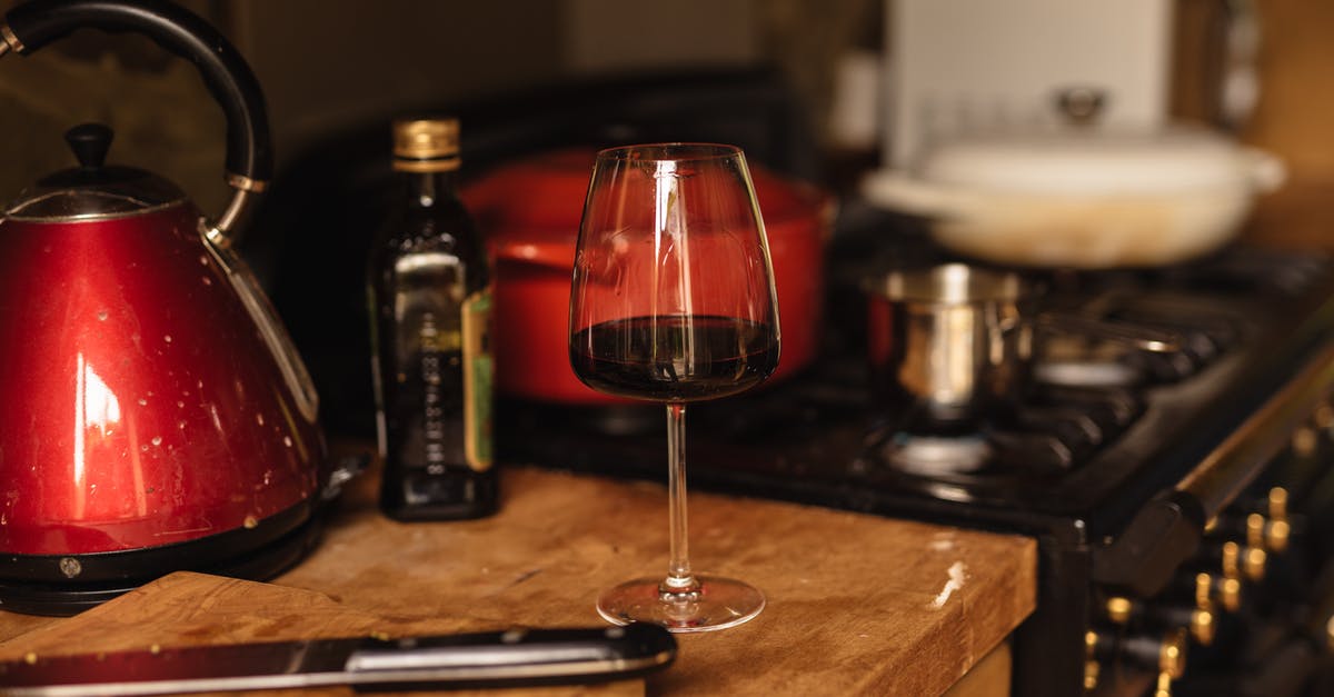 Can I keep mulled wine on the stove for longer - Wineglass placed on table near stone in kitchen