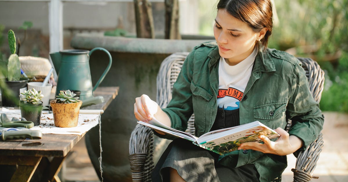 Can I learn to like wine? - Gardener reading book in armchair near plants in pots