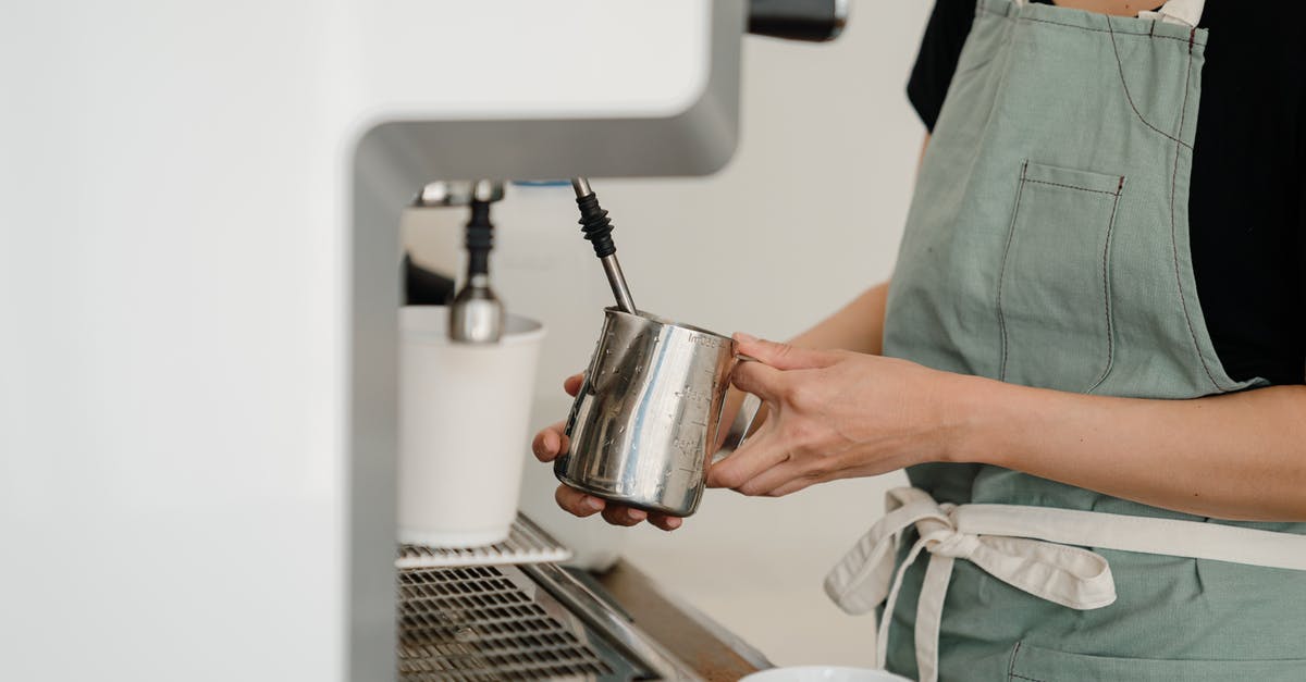 Can I make drinking milk with evaporated milk? - Crop coffee house worker making coffee using coffee machine