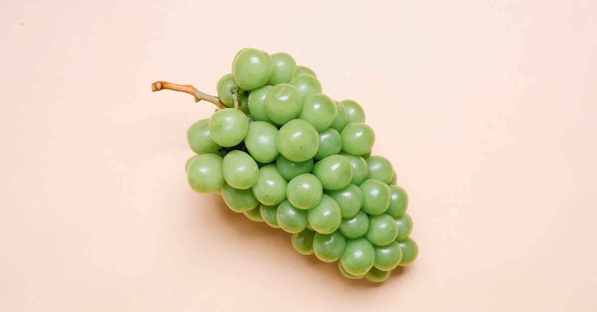 Can I make grapes honey from grape juice only - Top view of bunch of fresh delicious green grapes lying on beige surface