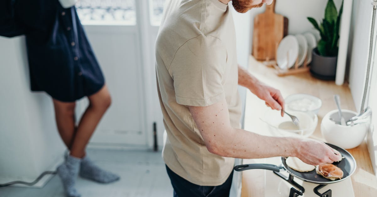 Can I make pancakes with a normal frying pan? - Man Wearing Beige Shirt While Cooking