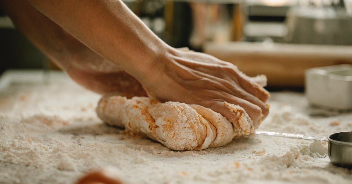 Can I partially bake a pie? - Unrecognizable woman kneading soft egg dough on table covered with flour in kitchen