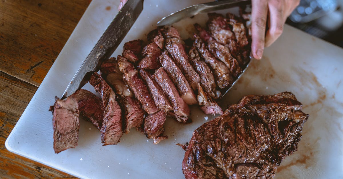 Can I put meat on a broiler rack without using foil? - Close-Up Shot of a Person Slicing Cooked Meat