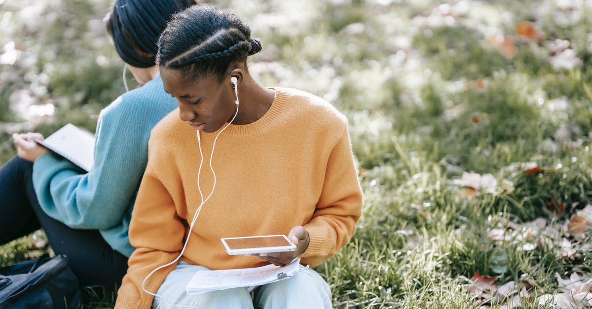 Can I season cast iron *without* using an oven? - Multiethnic women using tablet and reading in park