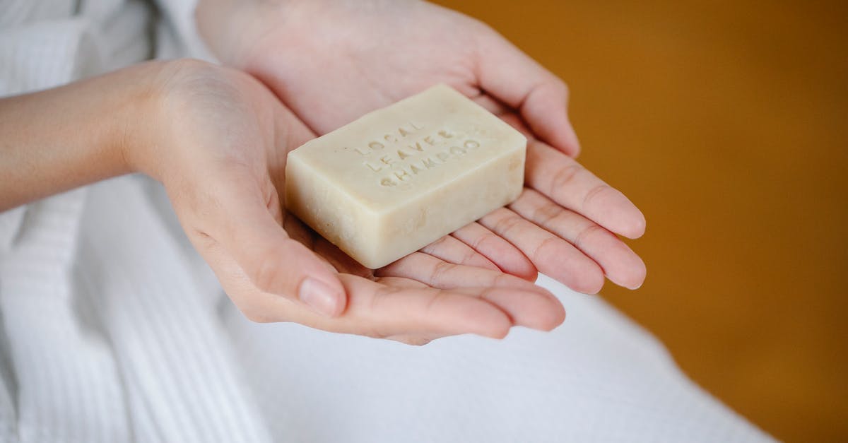 Can I still save my solid block of jam? - Crop anonymous female showing rectangular shaped dry ecological shampoo with title on blurred background