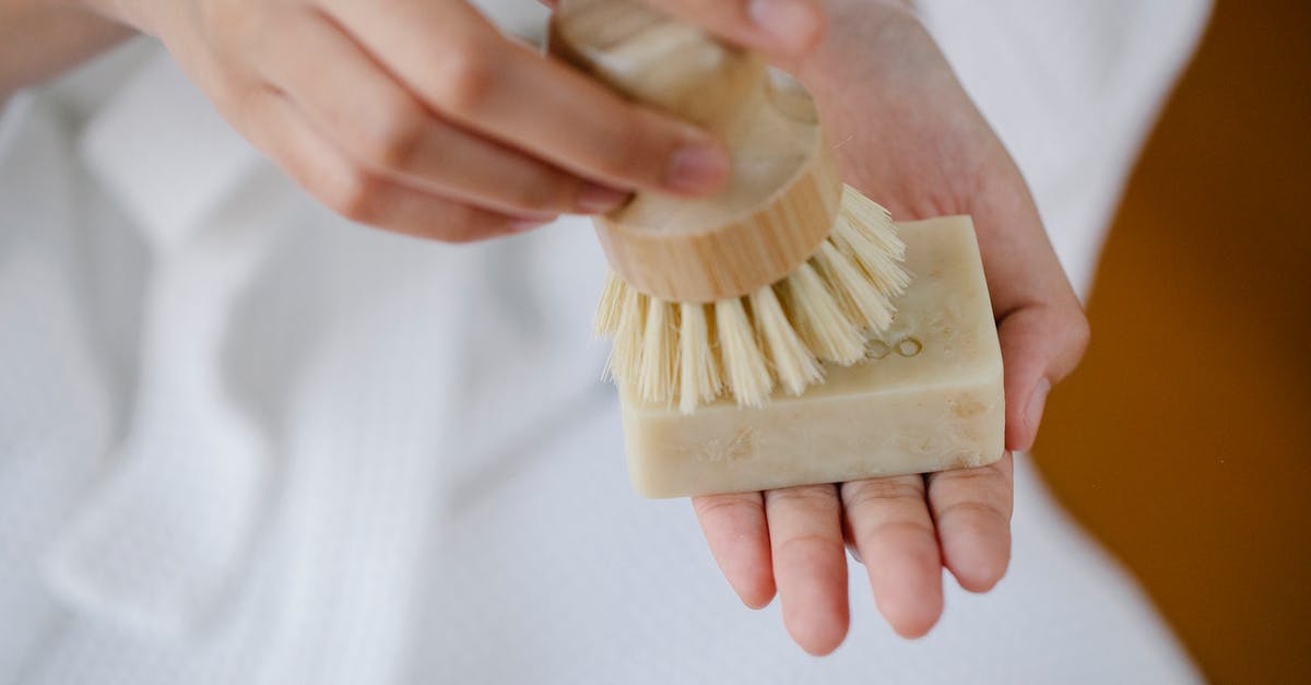 Can I still save my solid block of jam? - Crop unrecognizable female with eco friendly brush and soap block preparing for skin care on blurred background