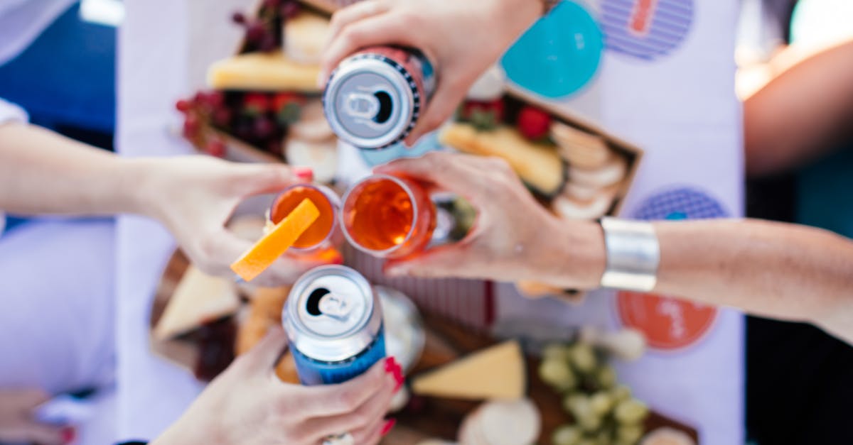 Can I substitute fresh tomatoes for canned? - Crop people clinking glasses over table