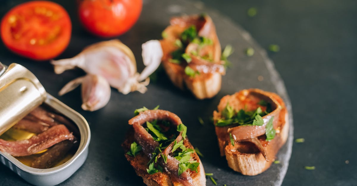 Can I substitute whole anchovies for anchovy paste? - Photo of a Can of Anchovies Near Bread