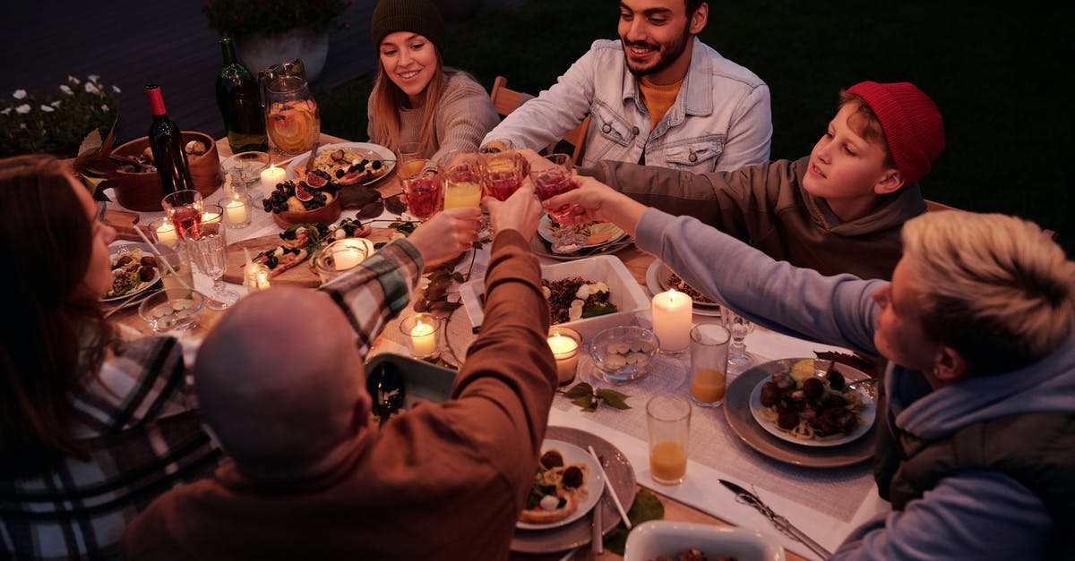 Can I toast pecans the night before? - From above multiethnic people with children spending evening at dinner in dusky garden and cheering with drinks